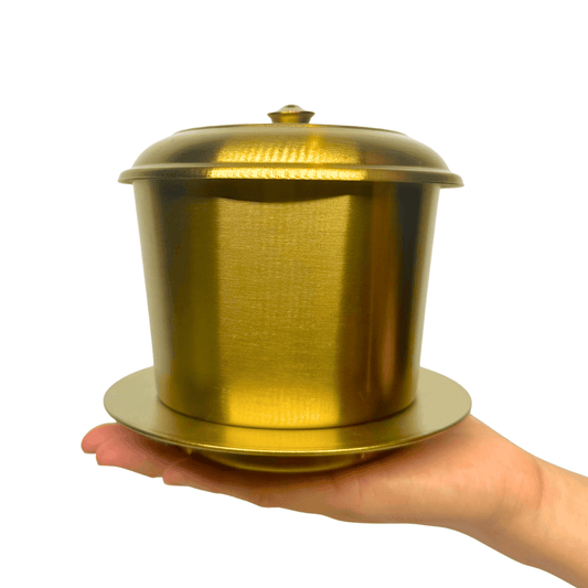 Large Stainless Steel Vietnamese Phin Filter (150g capacity) held in hand with a luxurious gold finish.