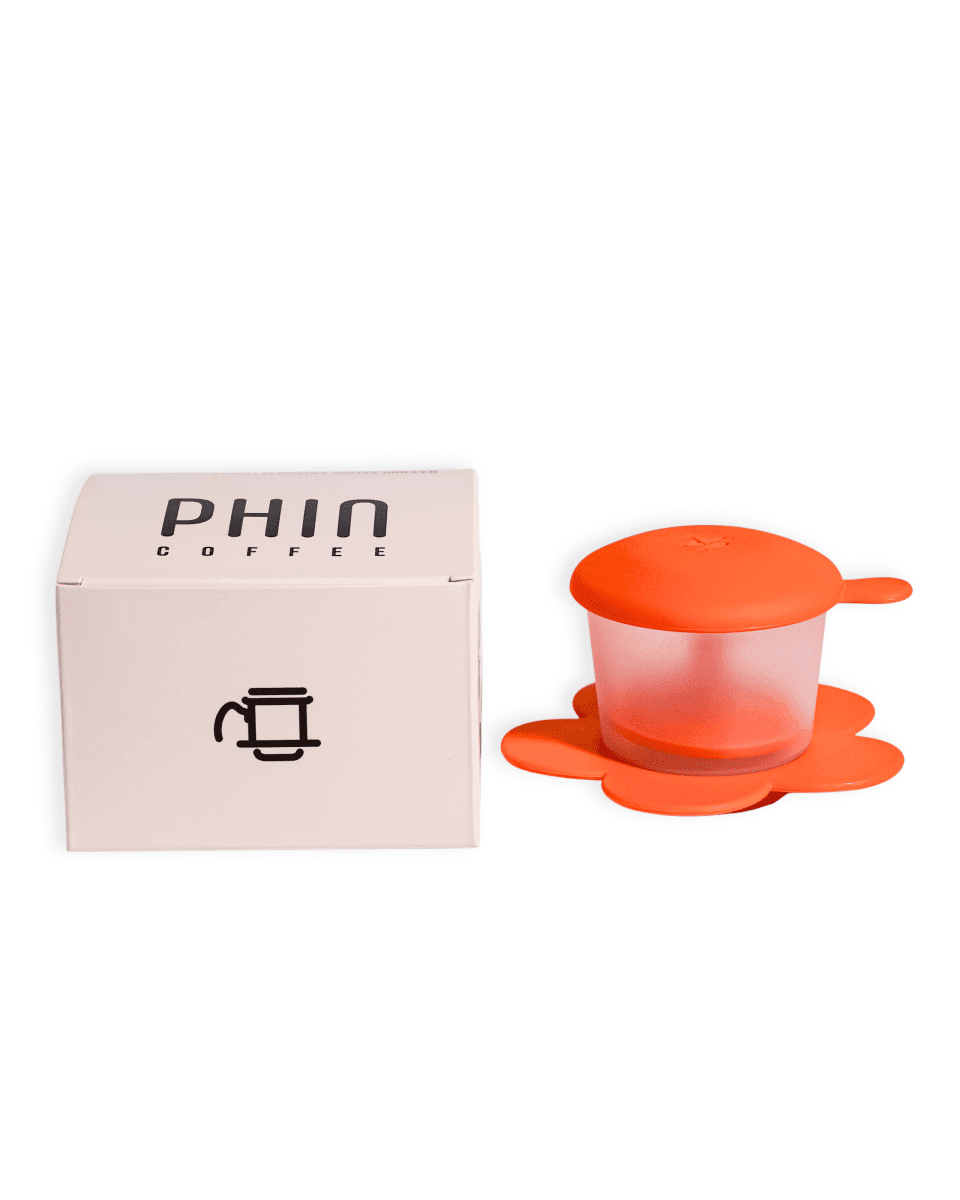 Transparent Phin Filter alongside its packaging for brewing freshly roasted Vietnamese coffee.