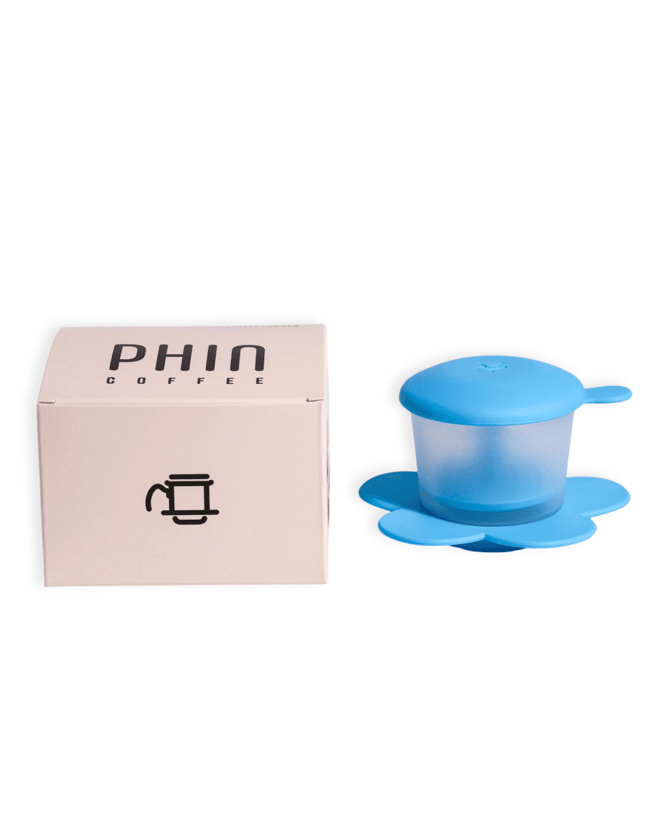 Vietnamese Phin Filter next to its packaging for brewing freshly roasted Vietnamese coffee.